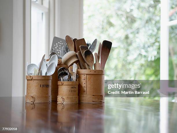 kitchen utensils in containers on table - kökstillbehör bildbanksfoton och bilder