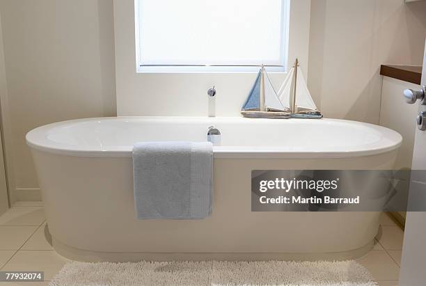empty bathtub with ships on ledge - bath toys stock pictures, royalty-free photos & images