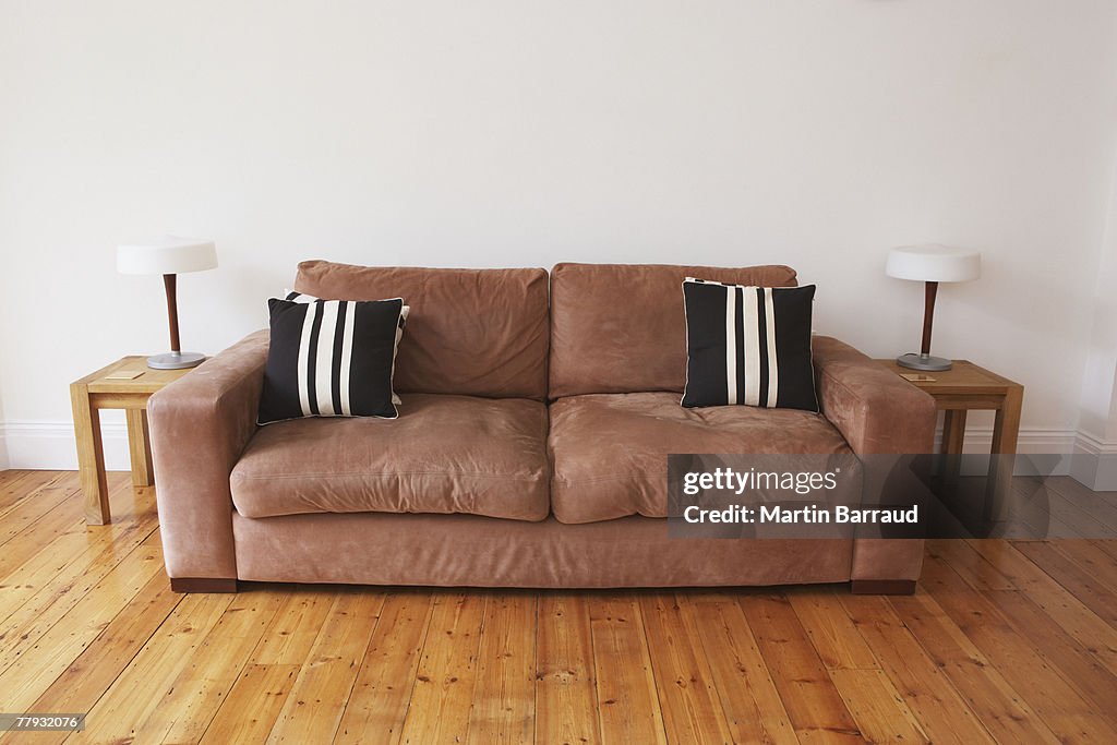 Empty living room with couch and end tables