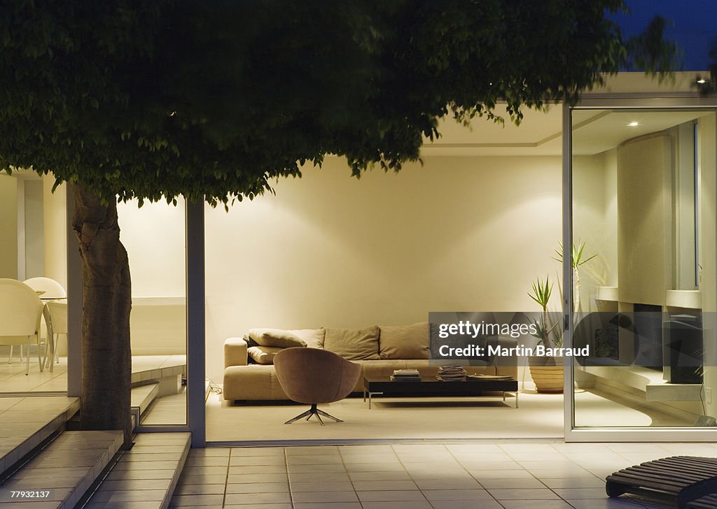 Modern living room and patio with sliding glass walls
