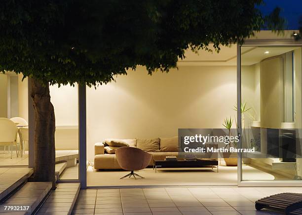 modern living room and patio with sliding glass walls - modern windows stock pictures, royalty-free photos & images