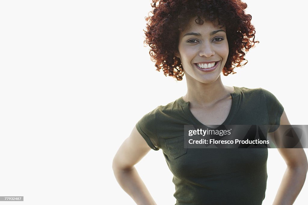 Woman smiling with hands on hips