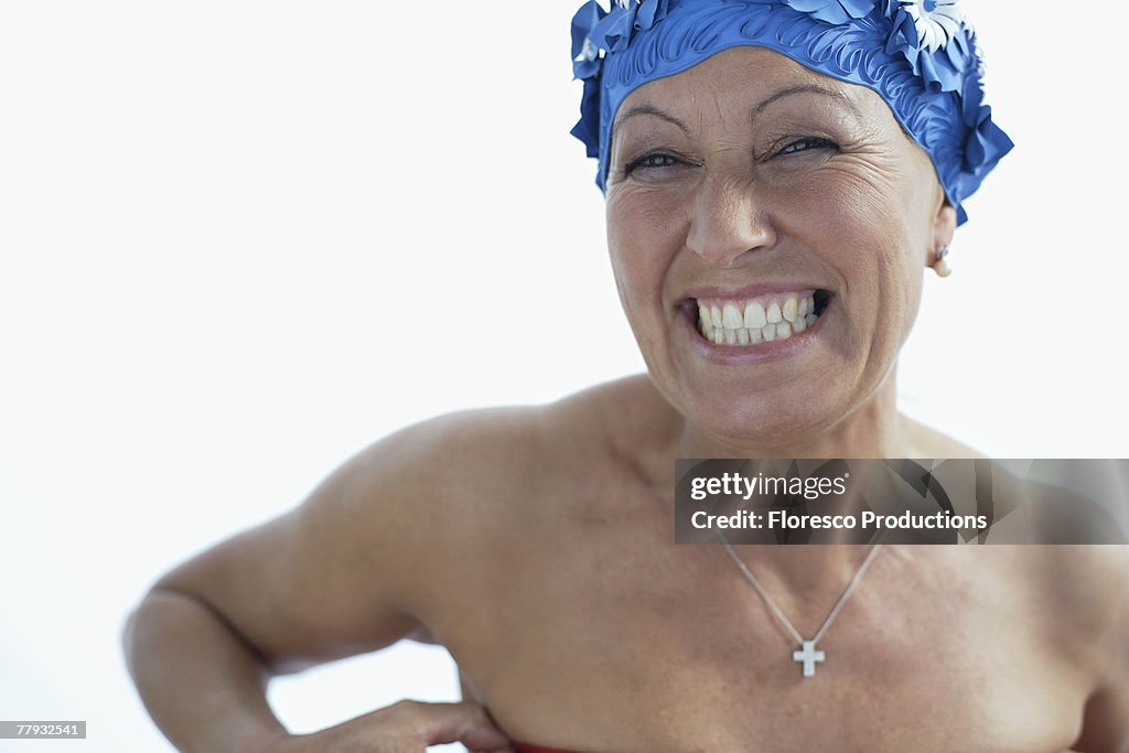 Woman wearing bathing cap smiling