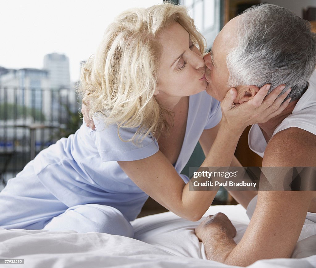 Couple kissing in bed
