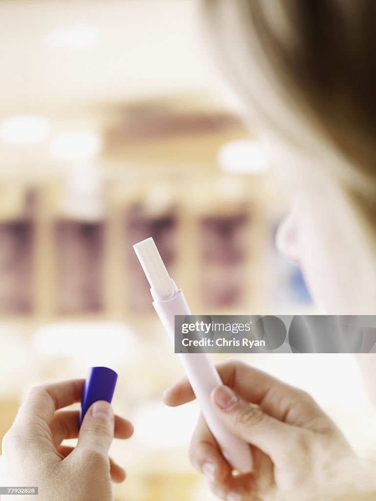 Woman holding pregnancy test