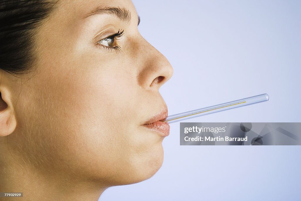 Woman with thermometer in mouth