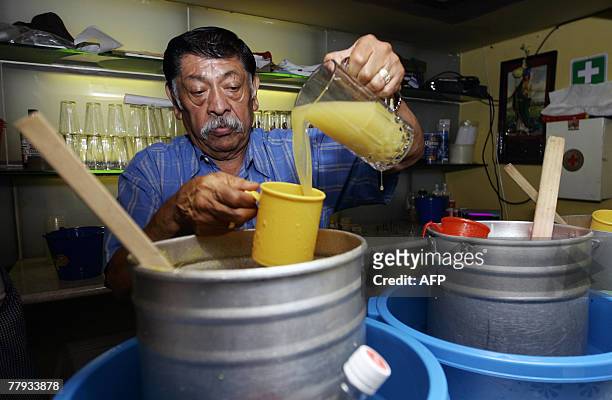 Epifanio Leyva pours pineapple pulque at "La Hija de Moctezuma" Bar, in Mexico City, 17 October, 2007. Pulque is a pre-Hispanic alcoholic beverage...