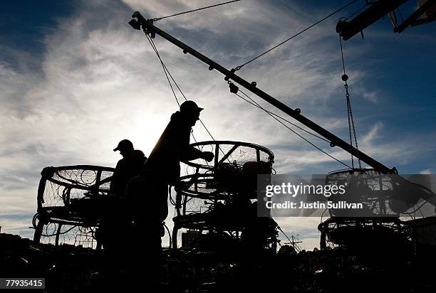 Crab fishermen take a break from loading crab traps onto their boat at Fisherman's Wharf November 15, 2007 in San Francisco, California. On the...