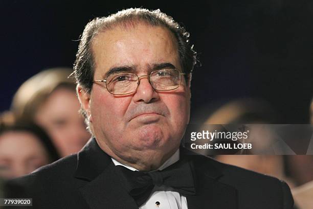 Supreme Court Justice Antonin Scalia listens as US President George W. Bush speaks at the the Federalist Society's 25th Anniversary Gala Dinner at...