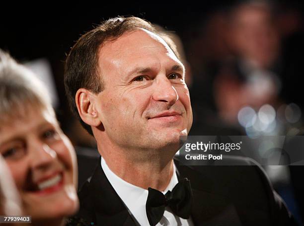 Supreme Court Justice Samuel Alito listens to U.S. President George W. Bush speak at the the Federalist Society's 25th annual gala at the Mayflower...