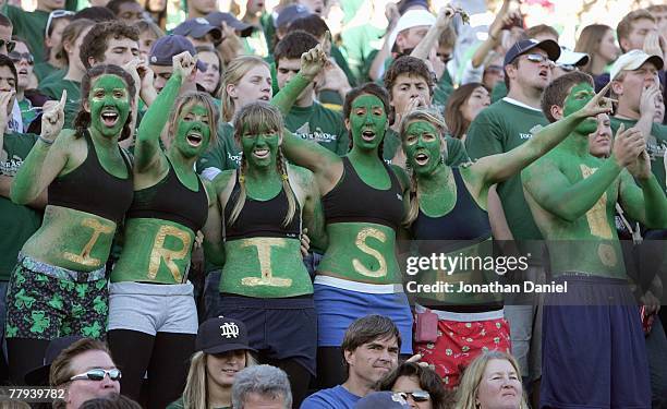 Women fans of the Notre Dame Fighting Irish dress in green paint cheer during the game against the University of Southern California Trojans at Notre...