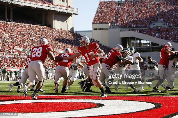 Todd Boeckman of the Ohio State Buckeyes hands off the ball to Chris Wells during the game against the Michigan State Spartans at Ohio Stadium...