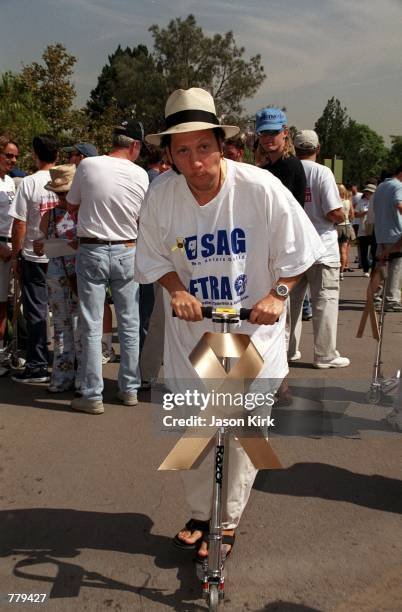 Actor Rob Schneider rides on a Razor at the La Brea Tarpits to support the March to Victory sponsored by the Screen Actors Guild September 13, 2000...