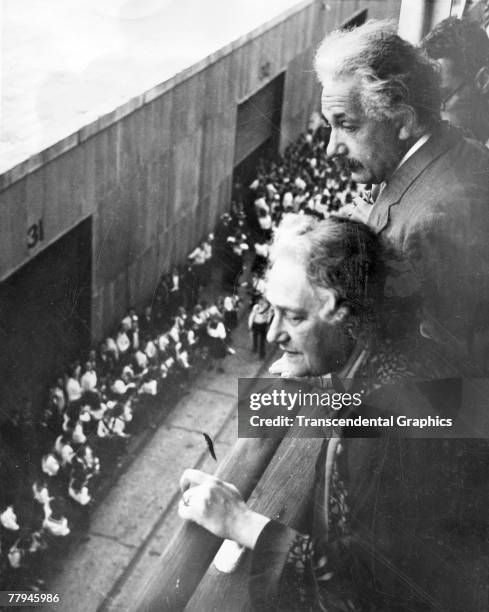 German theoretical physicist Albert Einstein and his wife Elsa Einstein look over the railing of the Red Star ocean liner SS Belganland at an...