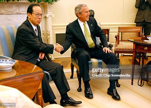 Japanese Prime Minister Yasuo Fukuda shakes hands with US President George W. Bush after a meeting in the Oval Office at the White House November 16,...