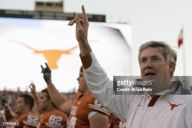 Head coach Mack Brown of the Texas Longhorns sings the 'Eyes of Texas' after defeating the Nebraska Cornhuskers for his 100th Texas win at Darrell K...