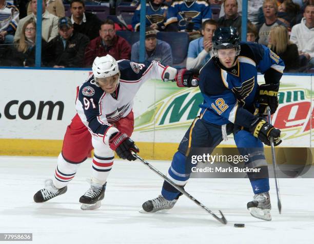 Sergei Fedorov of the Columbus Blue Jackets pokes the puck away from Lee Stempniak of the St. Louis Blues on November 16, 2007 at Scottrade Center in...