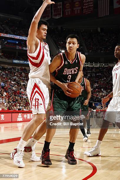 Yi Jinlian of the Milwaukee Bucks looks to make a move against Yao Ming of the Houston Rockets at the Toyota Center on November 9, 2007 in Houston,...