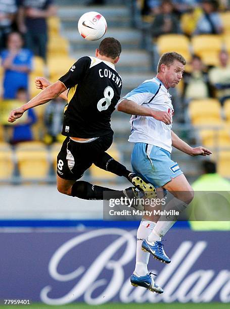 Vaughan Coveny of the Phoenix heads the ball in-front of Ufuk Talay of Sydney FC during the round 13 A-League match between the Wellington Phoenix...