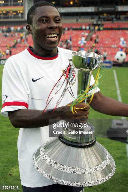 Freddy Adu celebrates with the trophy during the Nelson Mandela Challenge match between South Africa and United States held at Ellis Park Stadium on...