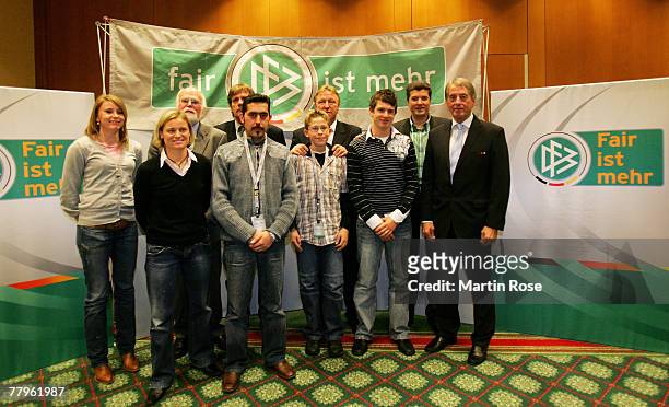 Junior coach of the DFB Horst Hrubesch and DFB vize president Rolf Hocke pose for a picture with the winners of the Fair Play trophy 2007 in...