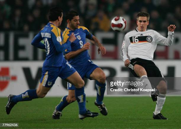 Constantinos Charalambides and Ioannis Okkas od Cyprus tackles Philipp Lahm of Germany during the UEFA Euro2008 Group D qualifying match between...