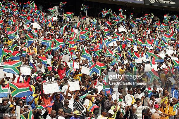 South African fans waves SA flags during the Nelson Mandela Challenge match between South Africa and United States held at Ellis Park Stadium...