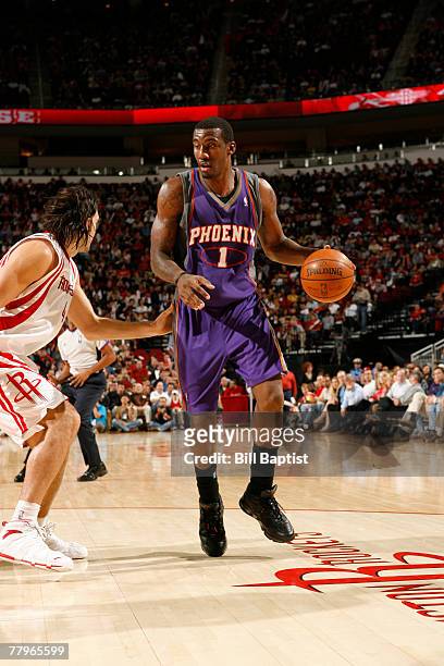 Amare Stoudemire of the Phoenix Suns dribbles the ball past Luis Scola of the Houston Rockets on November 17, 2007 at the Toyota Center in Houston,...
