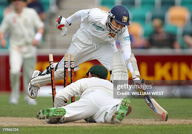 Sri Lankan batsman Mahela Jayawardena survives a run-out attempt from Australian wicketkeeper Adam Gilchrist on the third day of the second Test...