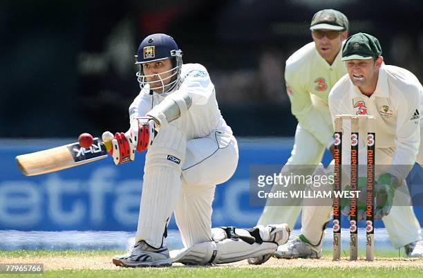 Sri Lankan batsman Mahela Jayawardena sweeps a ball away as Australian wicketkeeper Adam Gilchrist and Matthew Hayden look on during the third day of...