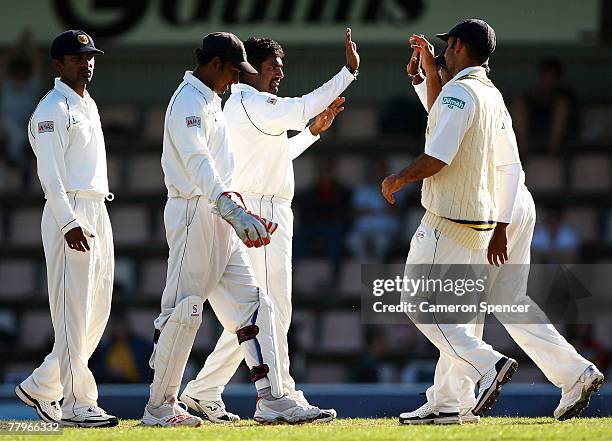 Muttiah Muralidaran of Sri Lanka celebrates with team-mates after taking the wicket of Matthew Hayden of Australia during day three of the Second...