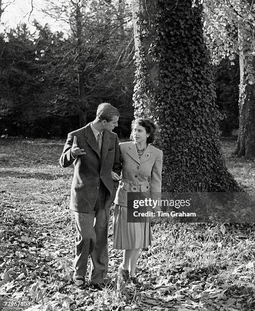 In this handout image from the Royal Collection, made available November 18 Princess Elizabeth and The Duke of Edinburgh walking in the grounds of...