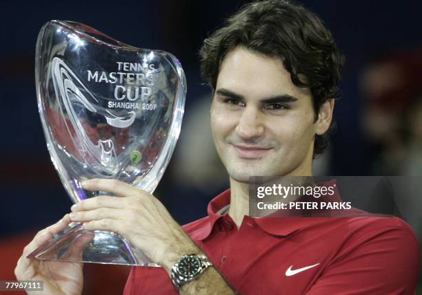 Roger Federer of Switzerland holds up his trophy after beating David Ferrer of Spain in the 2007 Tennis Masters Cup Shanghai final held at the...