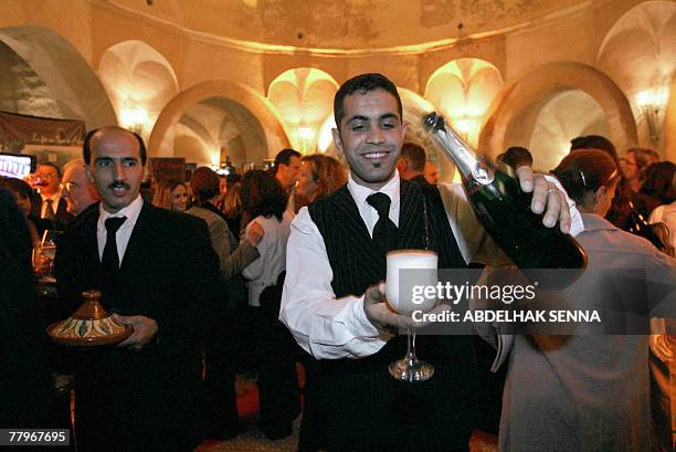 Le Maroc fete son vin dans la Meknes islamiste by Sammy Ketz A Moroccan waiter serves Champagne during the grapevines festival at the El Mansour...