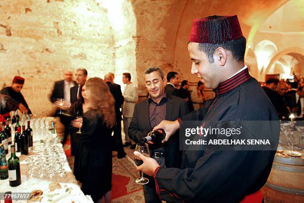 Le Maroc fete son vin dans la Meknes islamiste by Sammy Ketz A Moroccan waiter serves Champagne during the grapevines festival at the El Mansour...