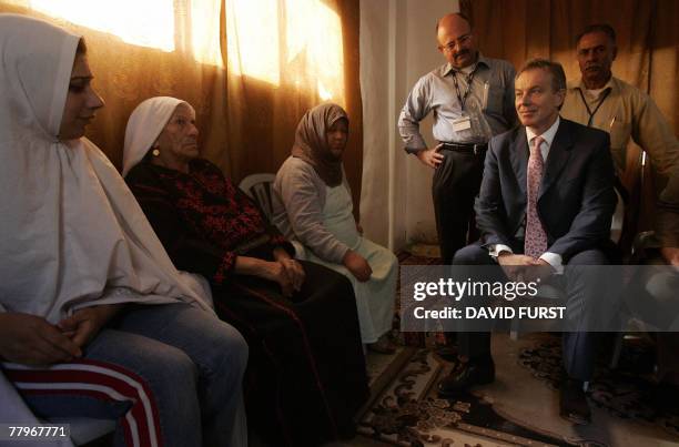 International peace envoy to the Middle East and former British prime minister Tony Blair meets with a Palestinian family in the Kalandia refugee...