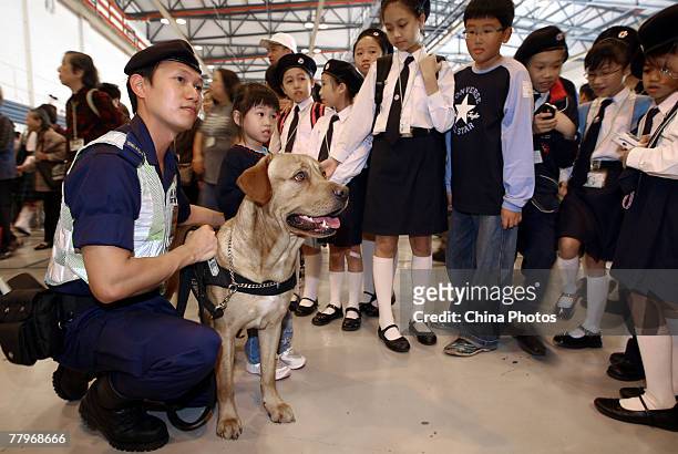 Children view police dog during the Government Flying Service Open Day on November 18, 2007 in Hong Kong, China. Flying demonstrations including the...