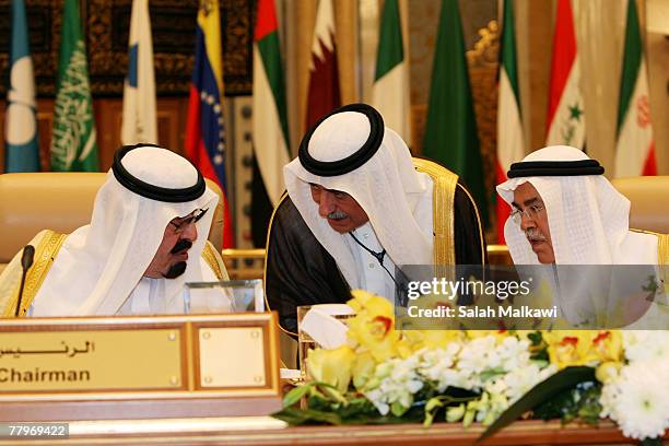 Saudi King Abdullah talks to Saudi Arabia's Oil Minister Ali al-Naimi and an unidentified Saudi delegate at the closing of the Third OPEC Summit ,...