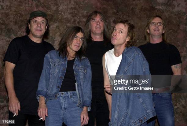Members of the Australian rock band AC-DC pose for a photograph after the Rock Walk handprint ceremony September 15, 2000 at the Guitar Center in...