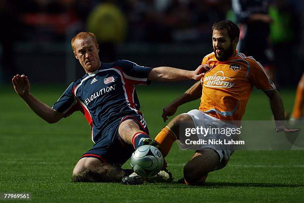 Brian Mullan of the Houston Dynamo and Jeff Larentowicz of the New England Revolution fight for the ball during the 2007 Major League Soccer Cup at...