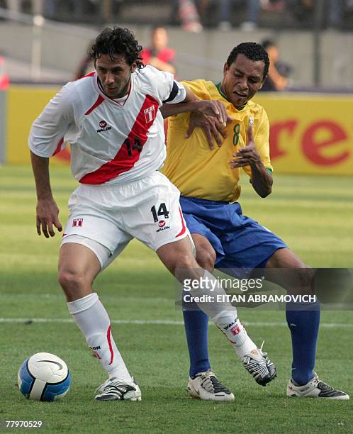 Peru's footballer Claudio Pizarro vies for the ball with Gilberto Silva of Brazil during their South American qualifying round match of the FIFA...