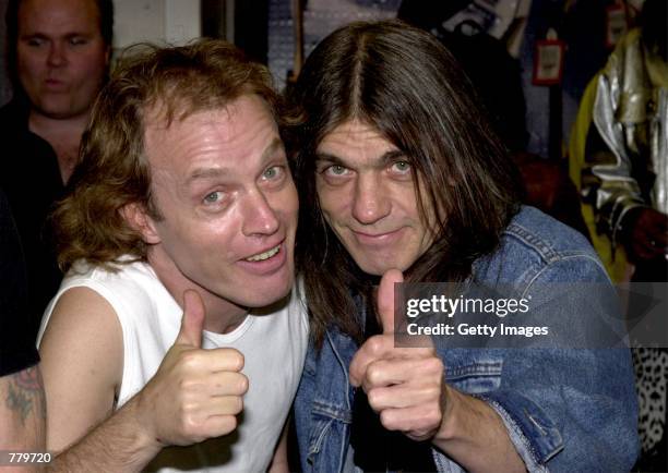 Band members Angus Young, left, and brother Malcolm Young of the Australian rock band AC-DC pose September 15, 2000 at the Rock Walk handprint...