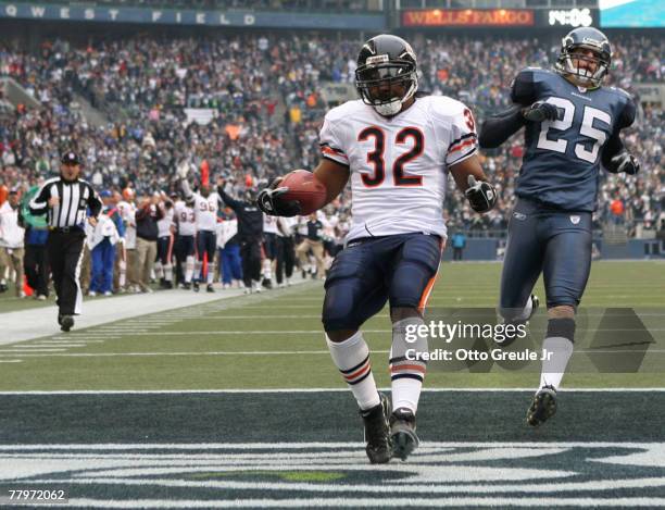 Running back Cedric Benson of the Chicago Bears scores a touchdown in the first quarter against Brian Russell of the Seattle Seahawks at Qwest Field...