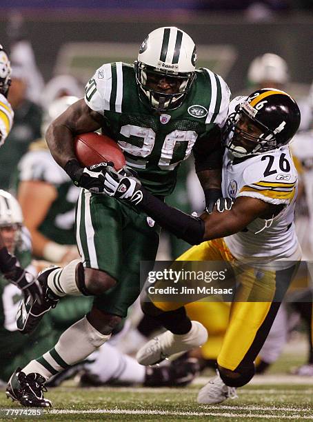 Thomas Jones of the New York Jets eludes the tackle attempt from Deshea Townsend of the Pittsburgh Steelers at Giants Stadium November 18, 2007 in...
