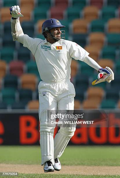 Sri Lankan batsman Kumar Sangakkara celebrates scoring his century against Australia on the fourth day of the second Test match in Hobart, 19...