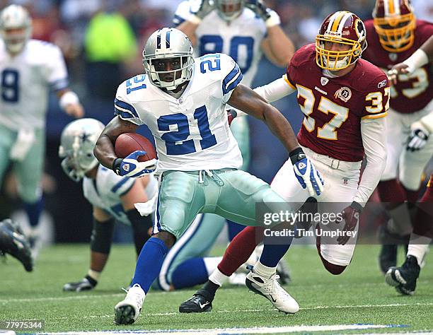 Running Back Julius Jones of the Dallas Cowboys runs the ball down field while being pursued by Safety Reed Doughty of the Washington Redskins at...