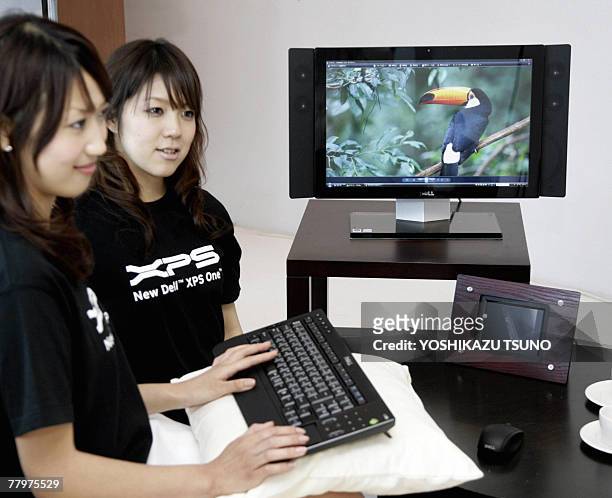 Computer giant Dell employees introduce the all-in-one desktop PC "XPS One" at a global launching in Tokyo, 19 November 2007. The "XPS One" is...