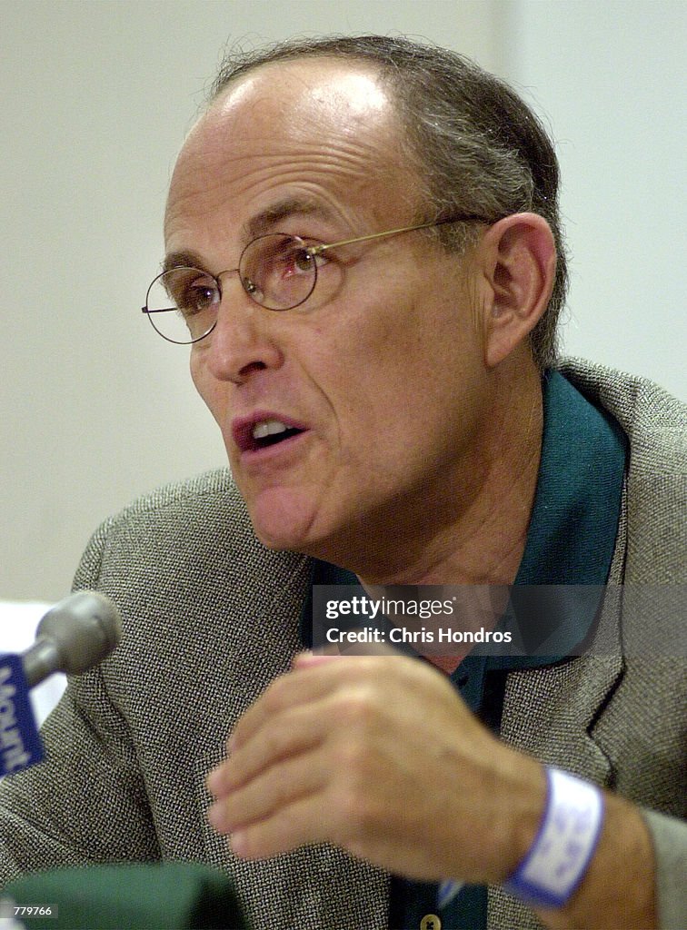 New York City Mayor Rudolph Giuliani, right, talks with reporters after surgery