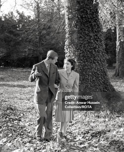 In this handout image from the Royal Collection, made available November 18 Princess Elizabeth and The Duke of Edinburgh walking in the grounds of...