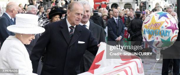 Britain's Queen Elizabeth II and Prince Philip unveil the Jubilee Walkway panel on Parliament Square in central London, 19 November 2007. Queen...